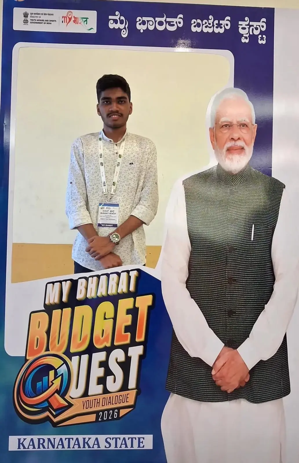 Standing in front of the MY BHARAT BUDGET QUEST promotional backdrop