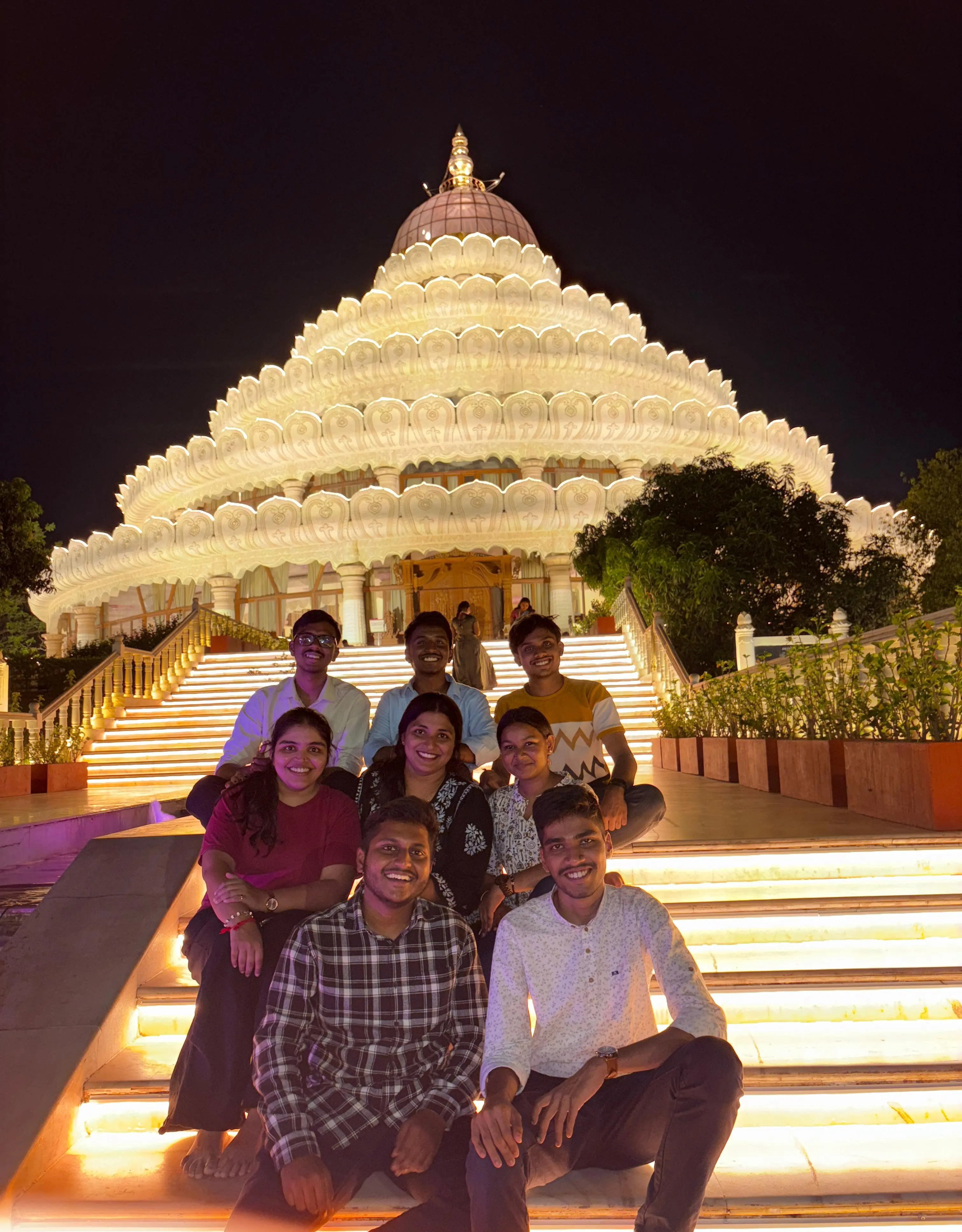 Seated group portrait on the illuminated steps