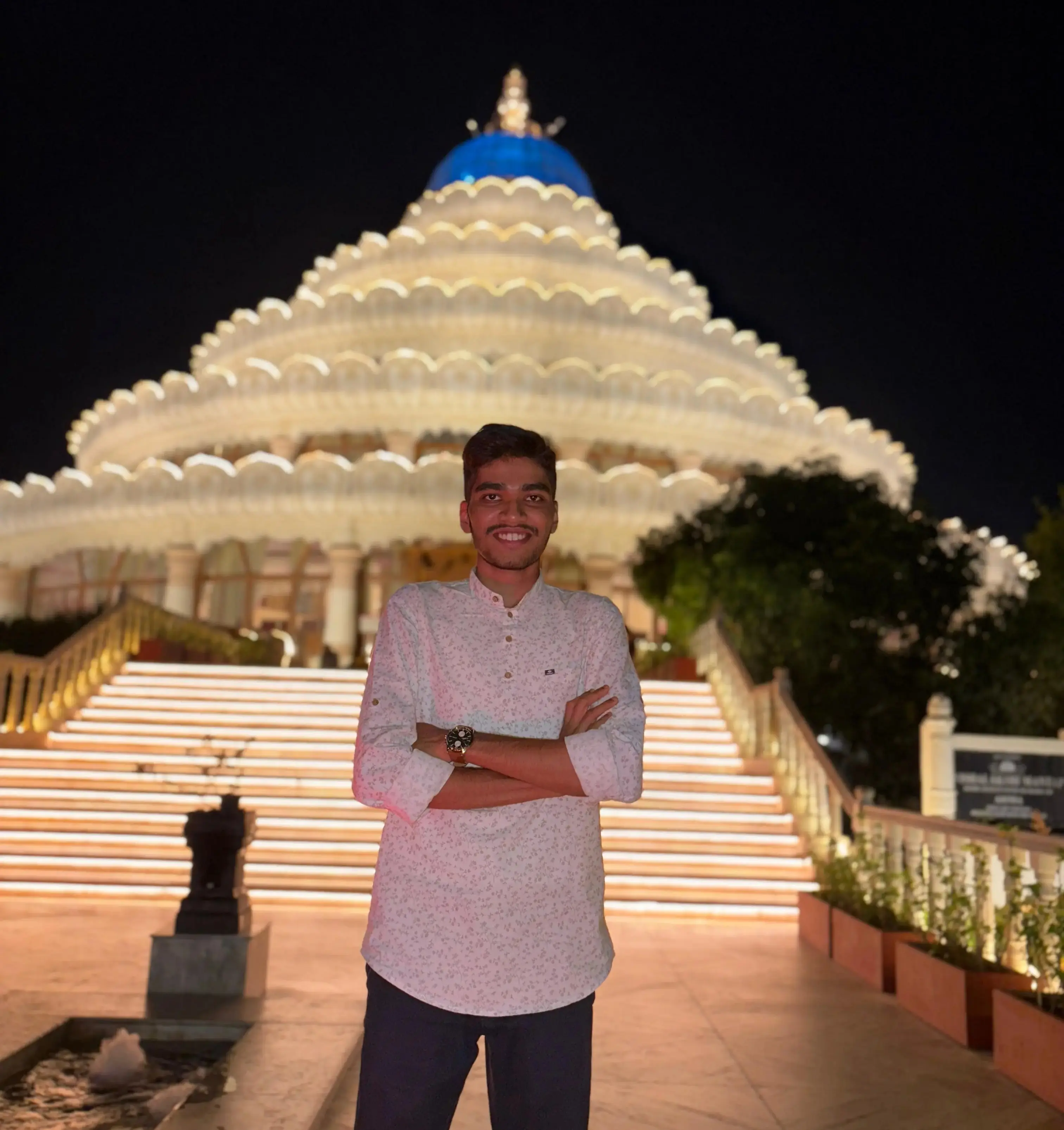 Wide night portrait in front of illuminated architecture