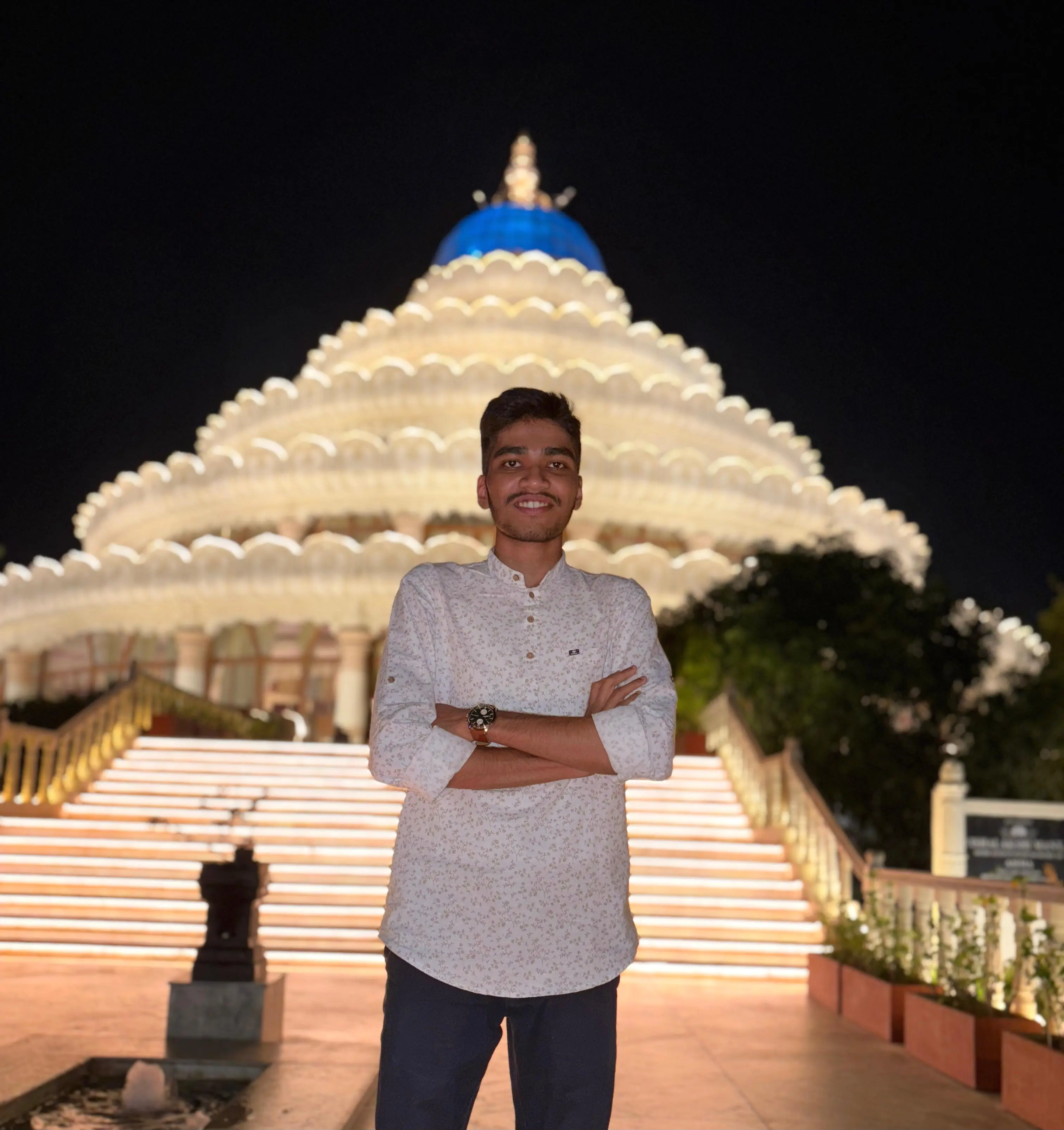 Zoomed night portrait in front of illuminated architecture